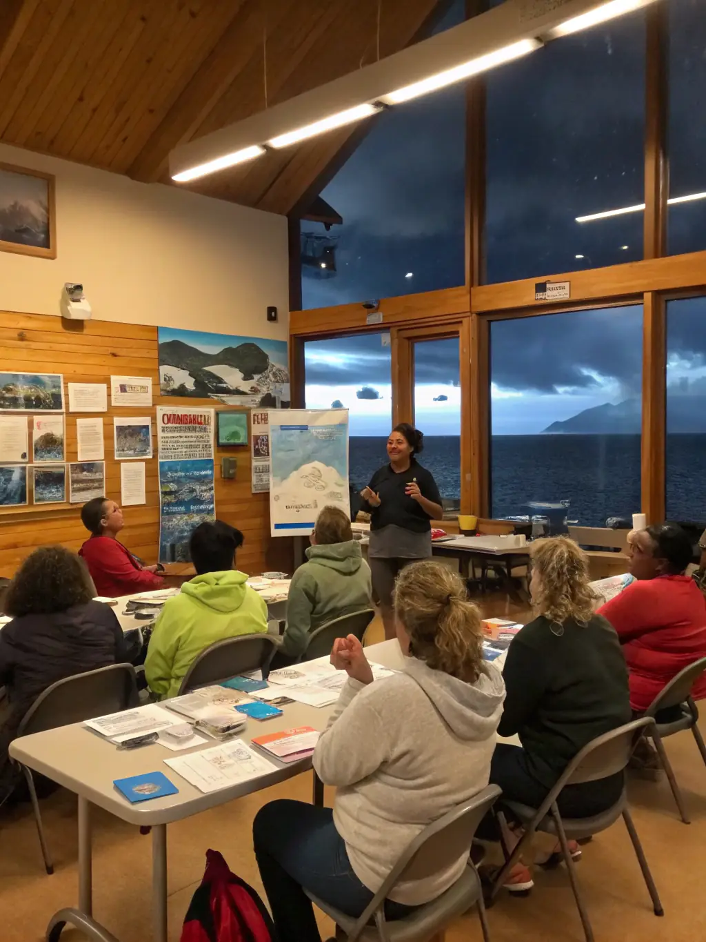 An image of a workshop where experts are teaching community members about sustainable fishing practices and the importance of biodiversity.